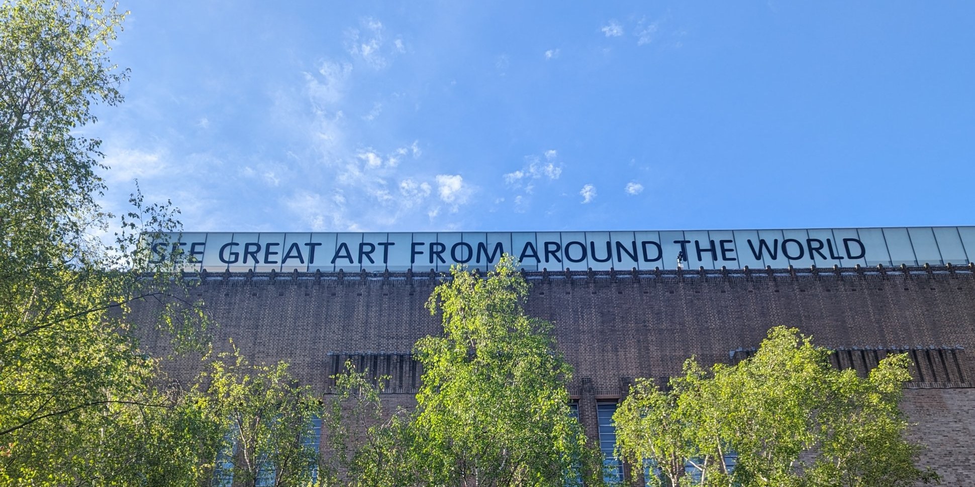 Tate Modern, with the words See great art from around the world along its roofline