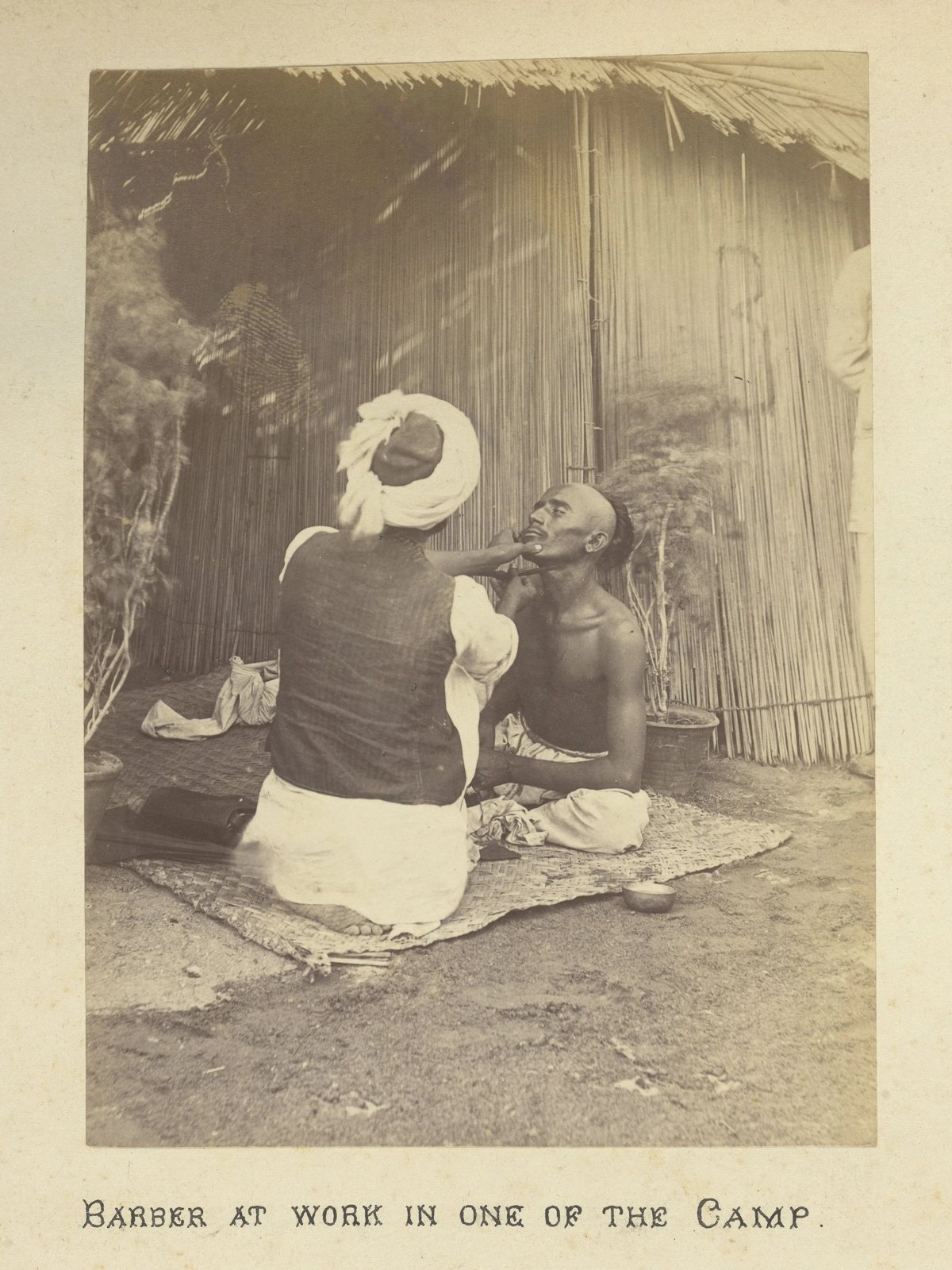 Archival photograph of a man at work in a plague camp