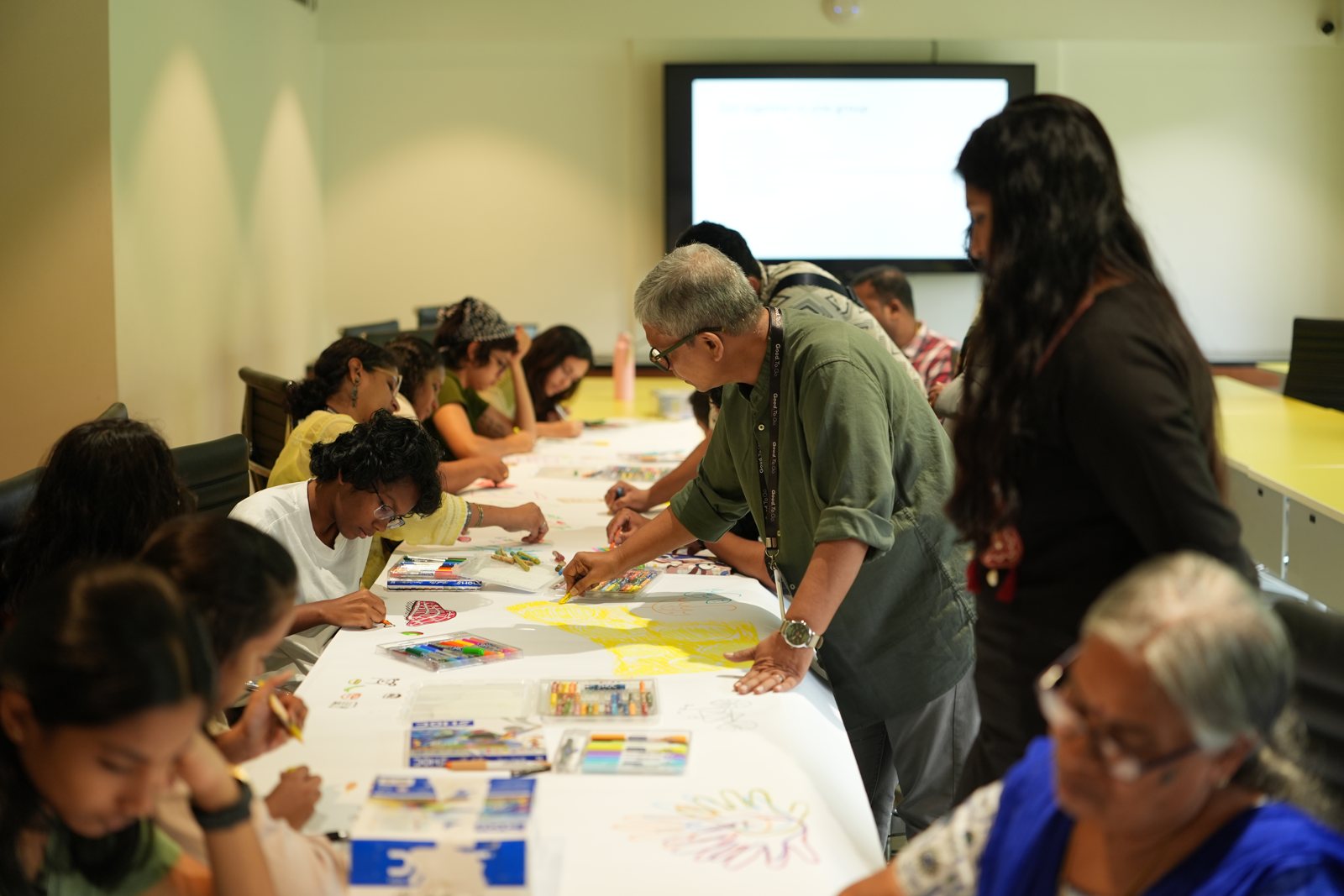 Children and adults painting at Good To Go