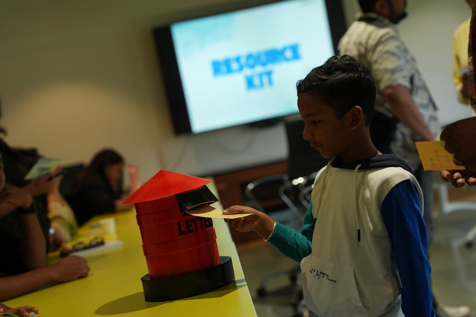 Children posting letters into a letterbox