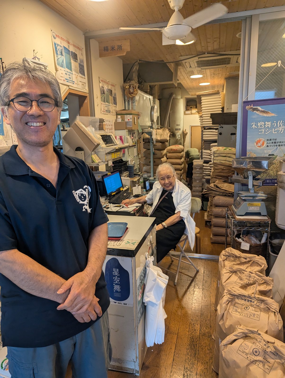 A rice merchant smiling in his store