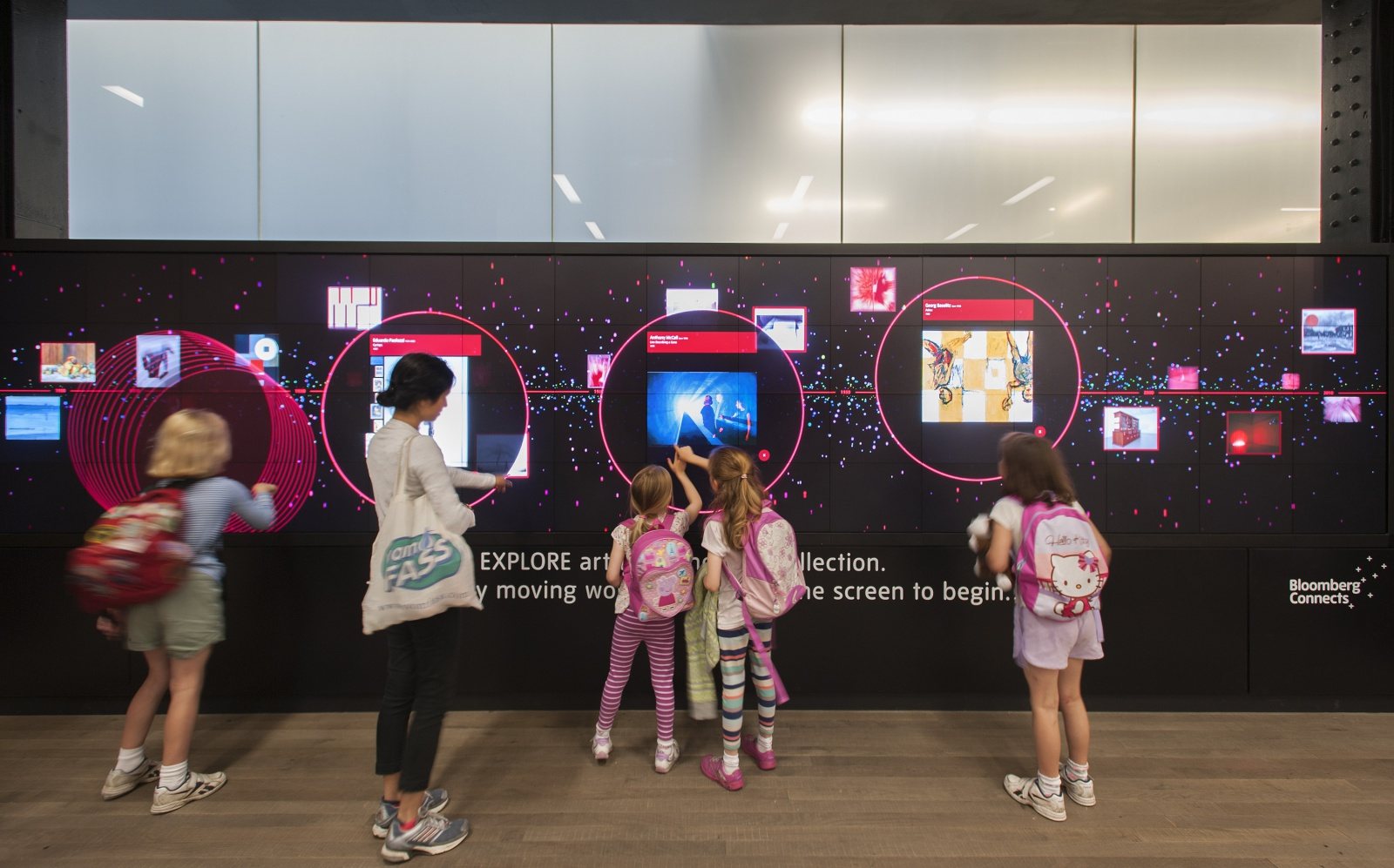 Children at an interactive screen wall
