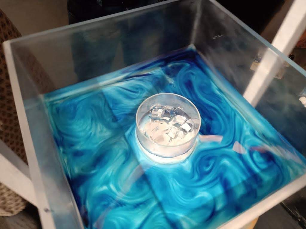 Blue dye swirling in a clear tank