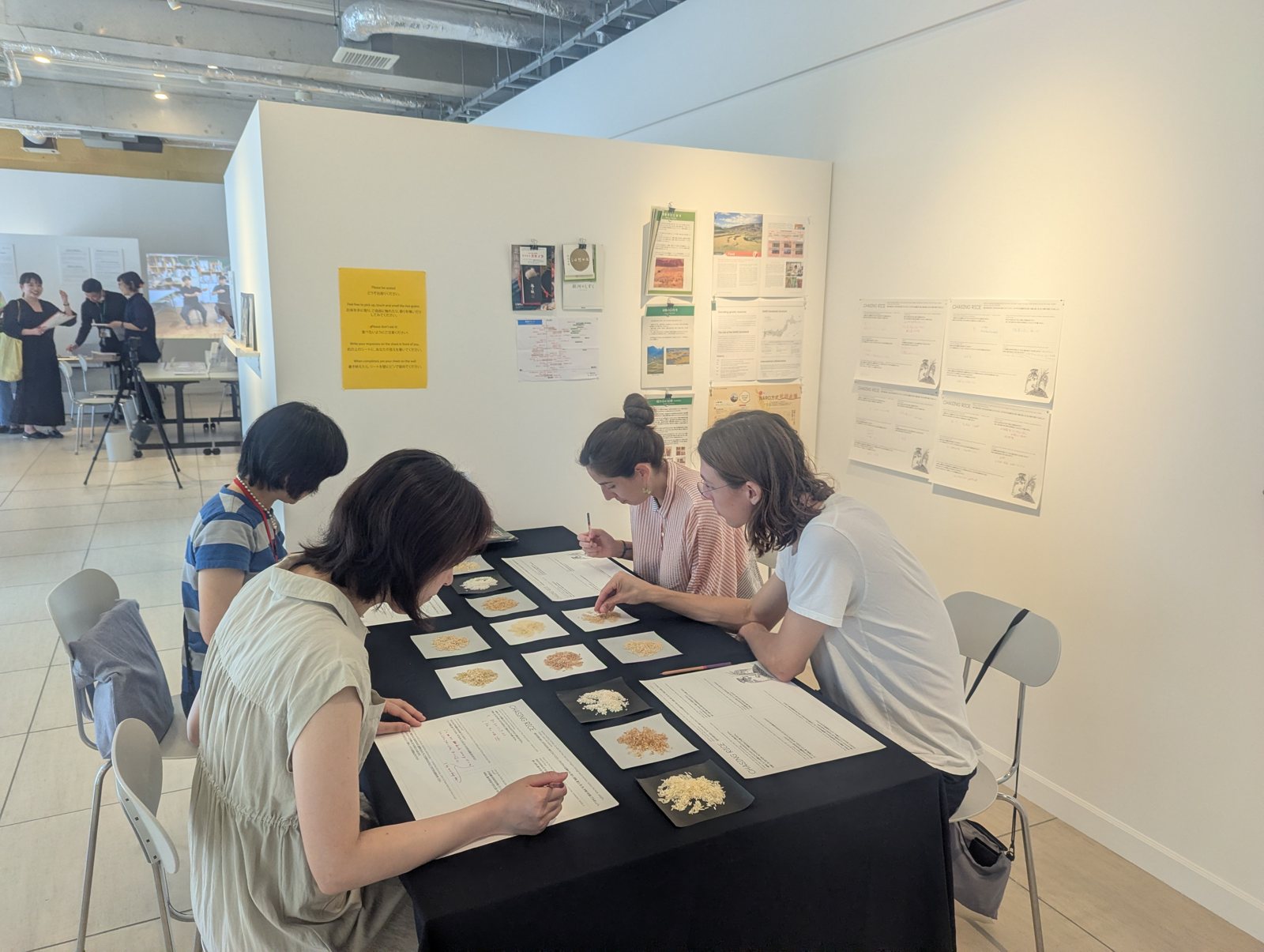 Visitors seated at the dining table in the studio