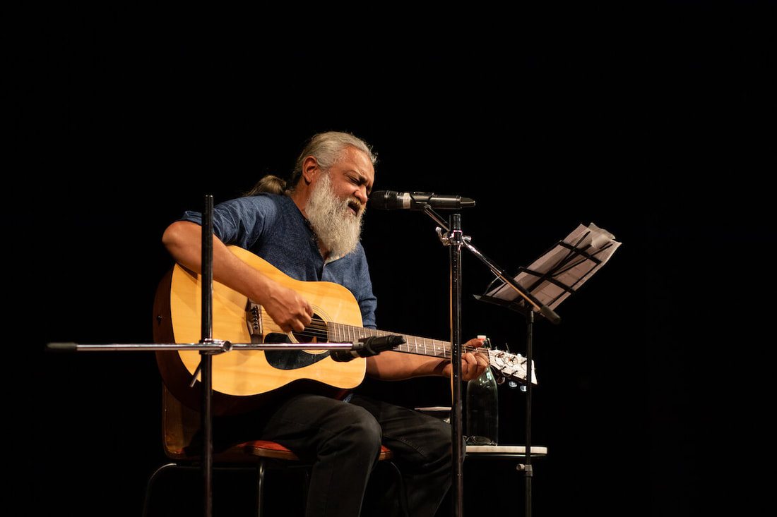 A musician performing with guitar