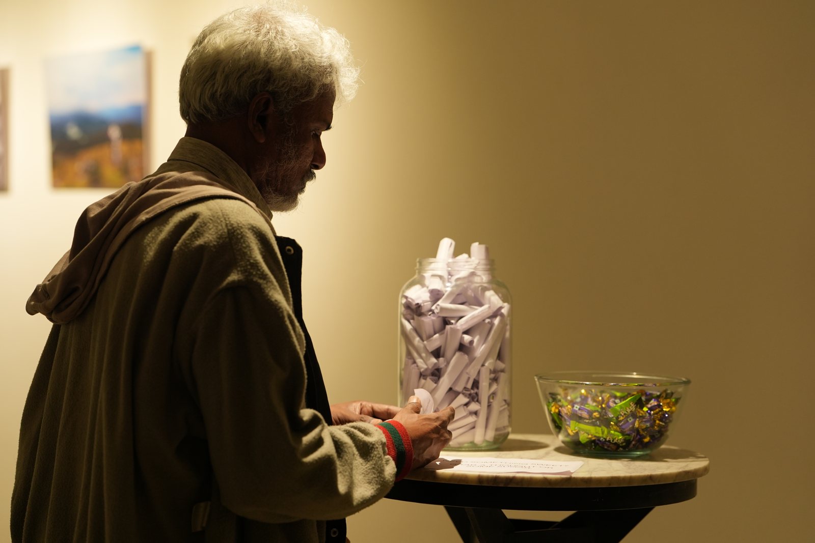 An older visitor at an interactive table