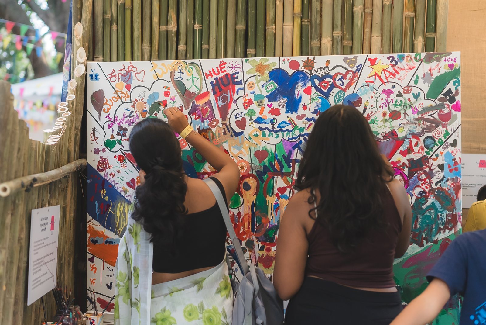 Visitors painting a collaborative wall