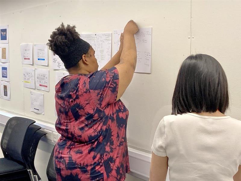 A participant pinning ideas to the wall