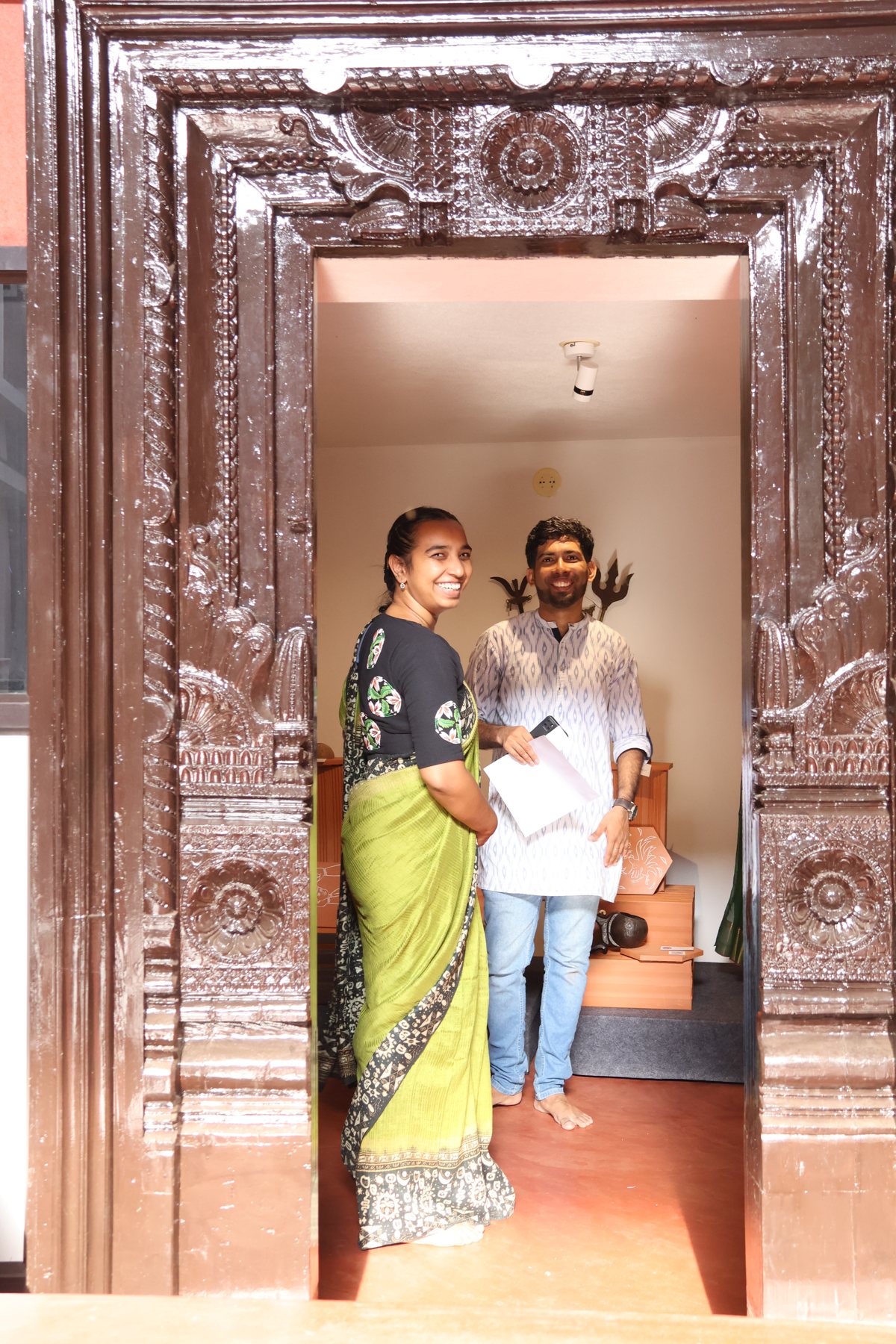 Visitors at a carved wooden doorway