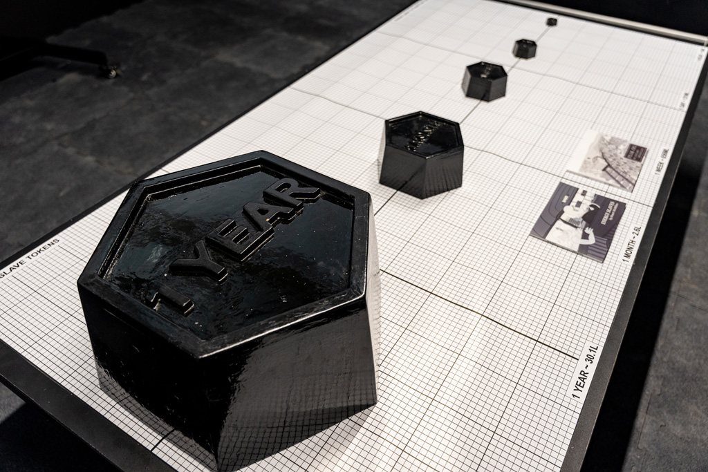 Hexagonal black objects on a gridded table