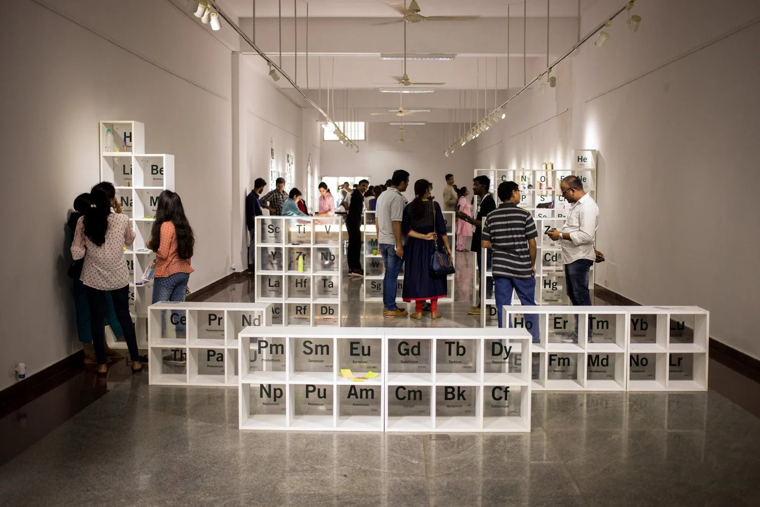 A long gallery with white cube shelving