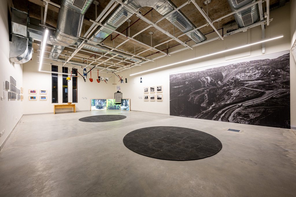 A wide gallery with a large black-and-white landscape print