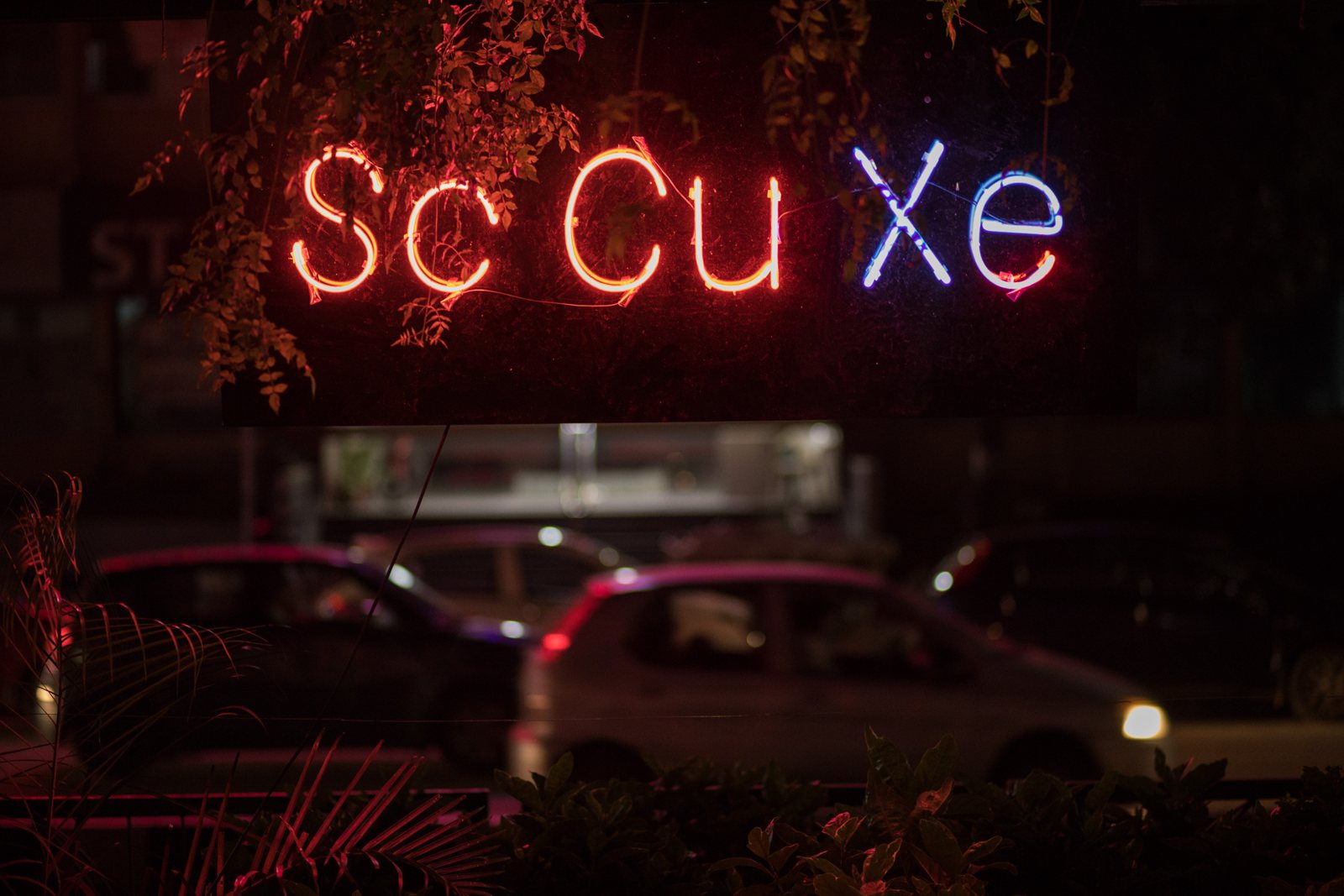 Neon sign reading Sc Cu Xe at night